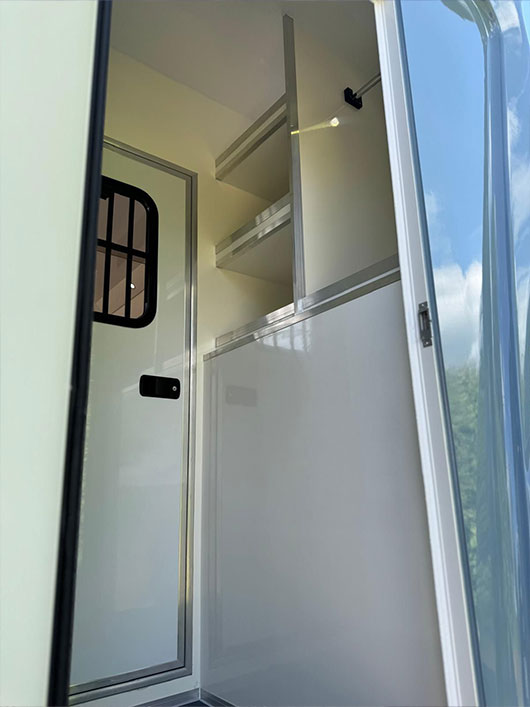 Built-in tack storage compartment inside a Piper Horseboxes Ltd horsebox. Perfect for equestrian travel.