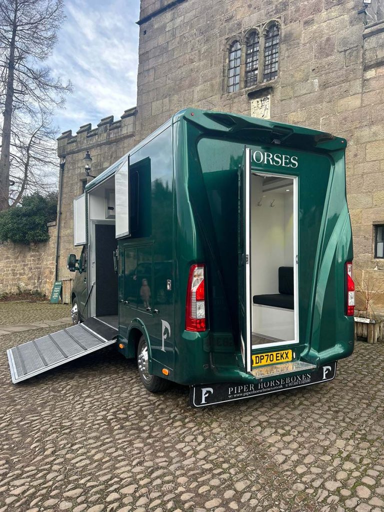 Racing green horsebox with back door and side ramp open