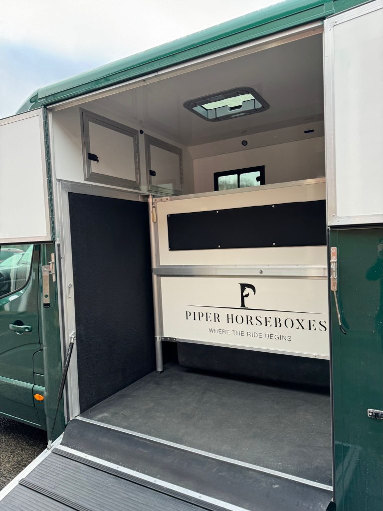 Open ramp of horsebox with Piper Horseboxes Ltd logo