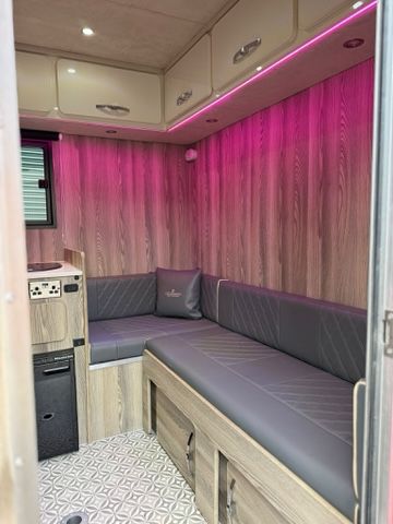 Pink lighting at seating area of Piper Horseboxes Ltd horsebox