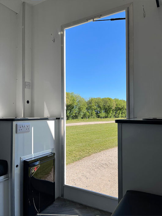 Back door of horsebox with mini fridge.