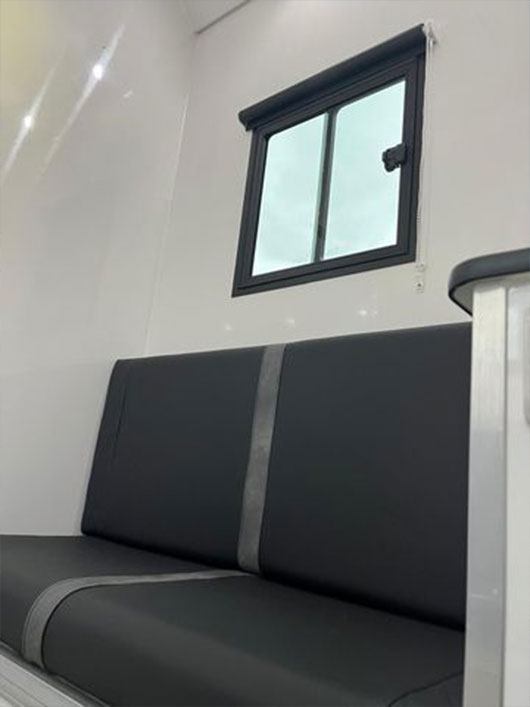 Seating llving space inside a Piper Horseboxes Ltd horsebox with modern finishes. Perfect for equestrian travel.