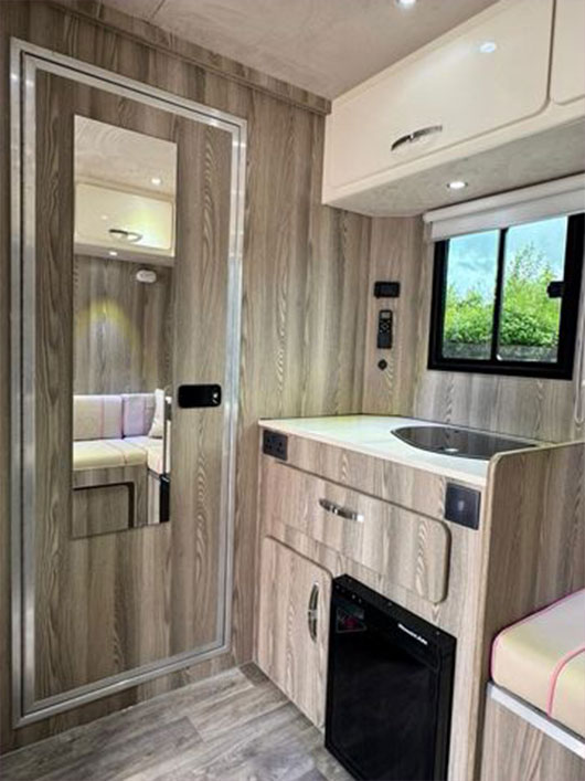 Modern seating area with extra comfort inside a Piper Horseboxes Ltd vehicle. Perfect for equestrian travel.