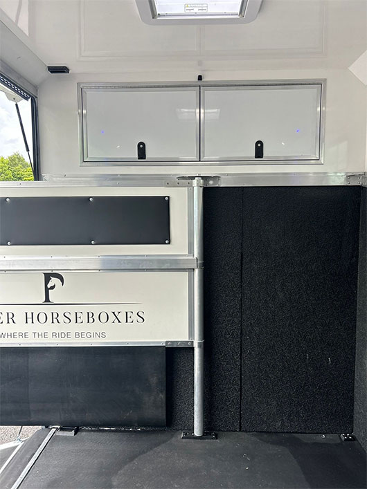 Well-lit horse area inside a Piper Horseboxes Ltd custom horsebox. Perfect for equestrian travel.