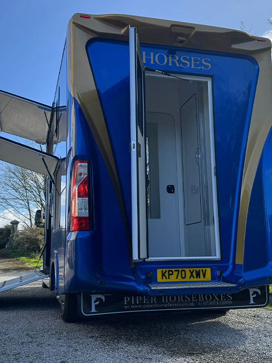 Rear view of a blue and gold Piper Horseboxes Ltd horsebox in Lancashire. Perfect for horse shows and travel.